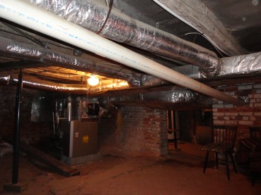 Before renovation - low-hanging HVAC ducts, note plumbing pipe running through interior brick wall at right.?????????????????????????????????????????????????????????????????????????????????????????????????????