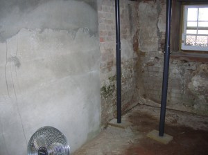 Basement before renovation - North side northeast corner and fireplace